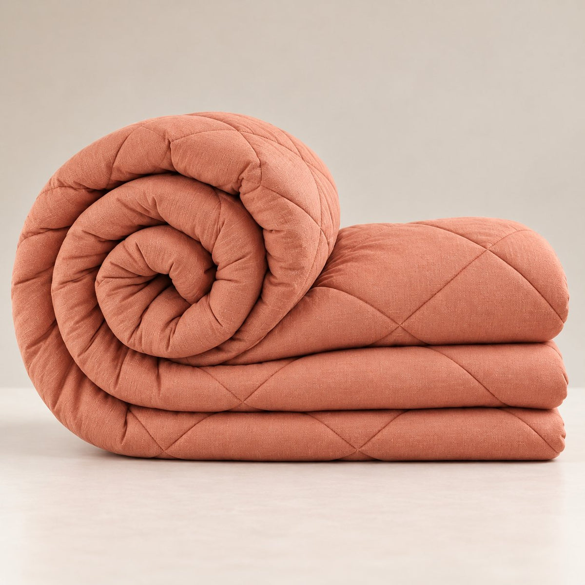 Peach Shir-o-Shakar Seersucker Comforter by Reet (peach seersucker AC comforter, light orange / pink, double bed 90x100) — rolled to show softness